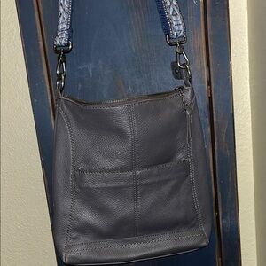 The Sak grey leather crossbody with blue and grey strap.